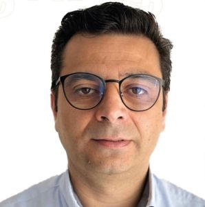 Retrato frontal de uma pessoa com cabelo escuro e óculos, sobre fundo branco. Não há texto visível que permita identificá-la.