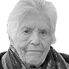 Retrato a preto e branco, em primeiro plano, de uma pessoa idosa a olhar para a câmara. O fundo é claro e não há texto visível.